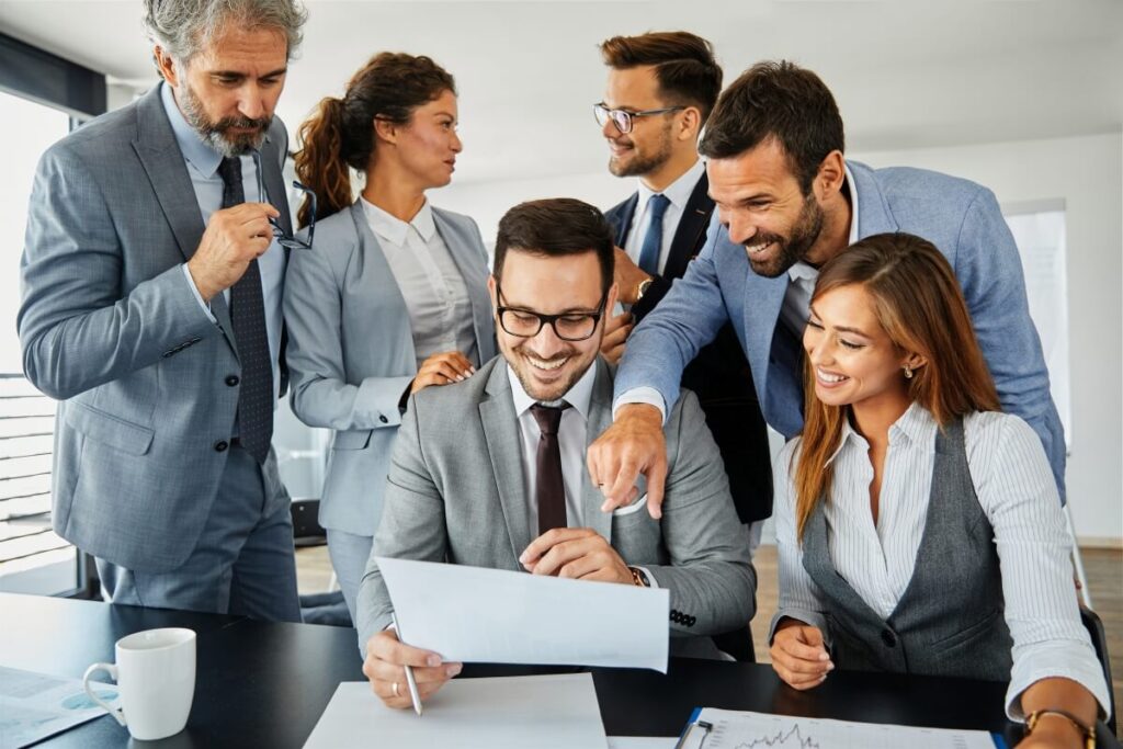 Grupa prawników omawia dokumenty w kancelarii adwokackiej.